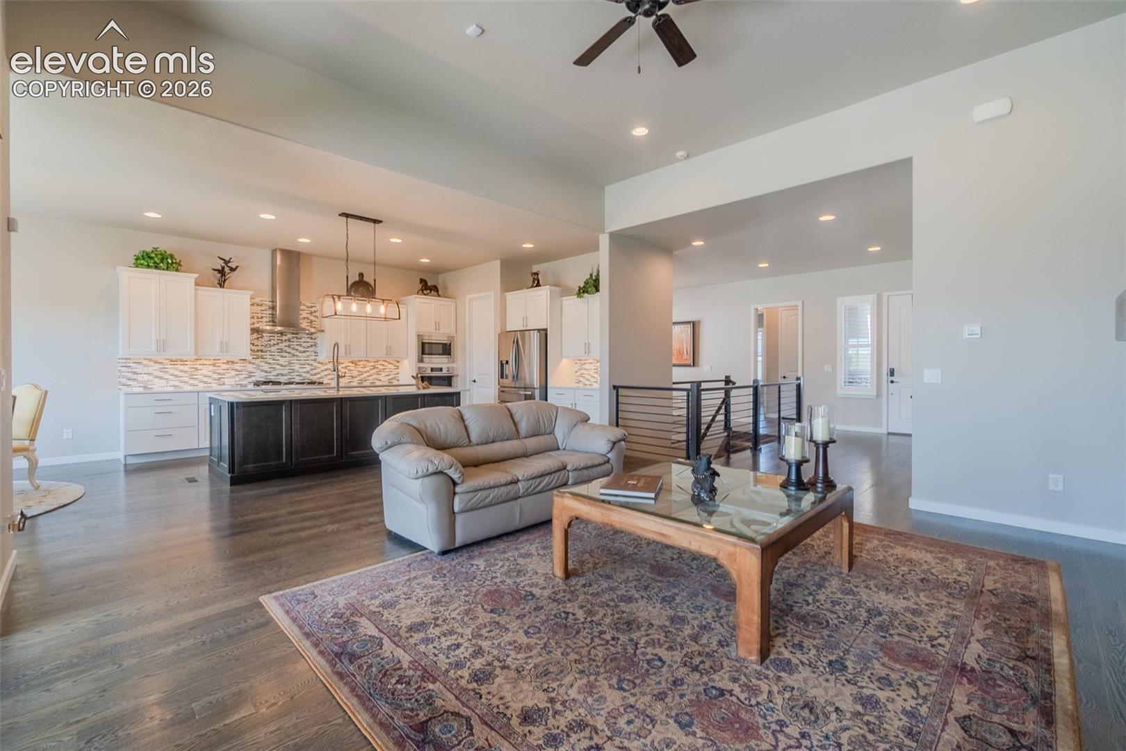 Open-concept living area with dark wood-finish flooring