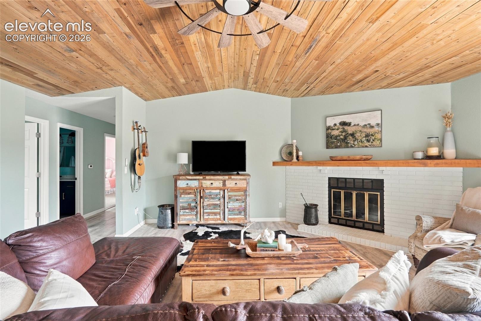Vaulted wood-paneled ceiling with ceiling fan