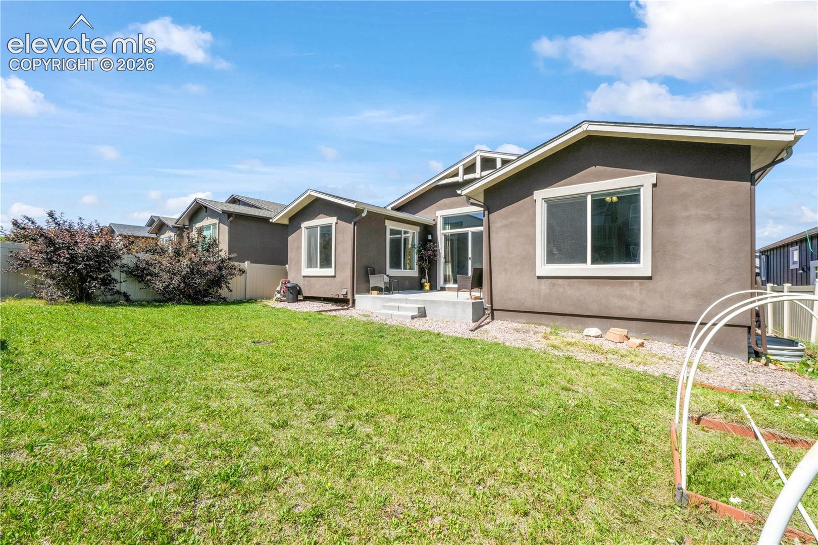 Back of home, patio and landscaping