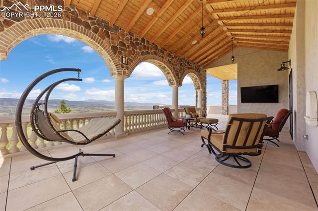Spacious covered deck with curved viewing balcony.