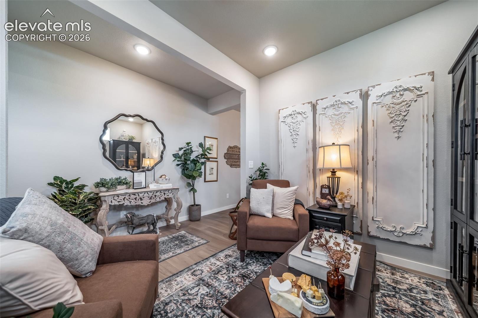 Recessed lighting illuminates an interior space featuring light-toned walls and wood-finish flooring
*Photos of a model home*