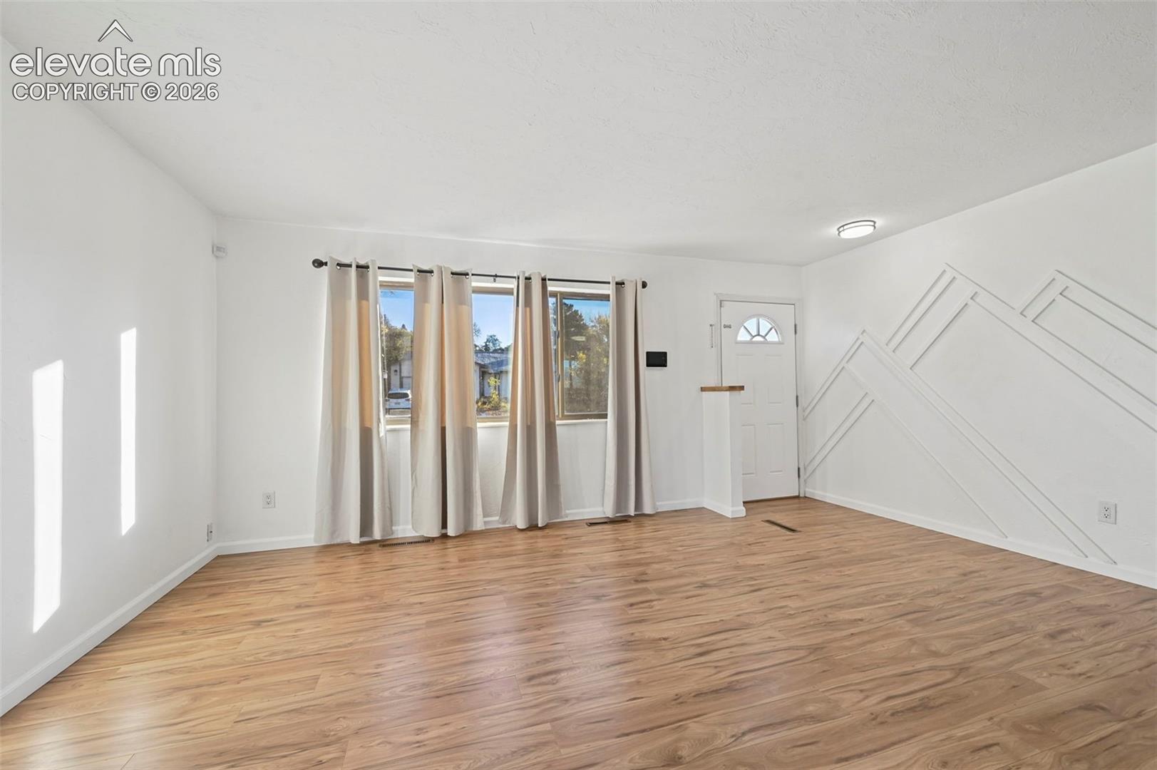 Beautiful new flooring and custom accent wall here in the living room! 