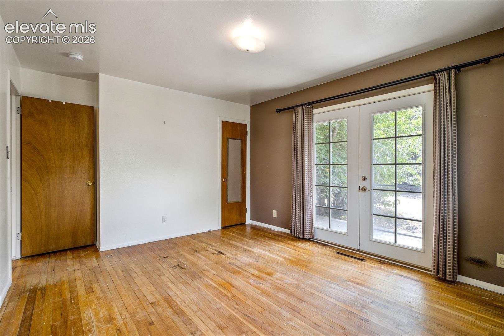 Primary Suite with french doors out to the backyard 