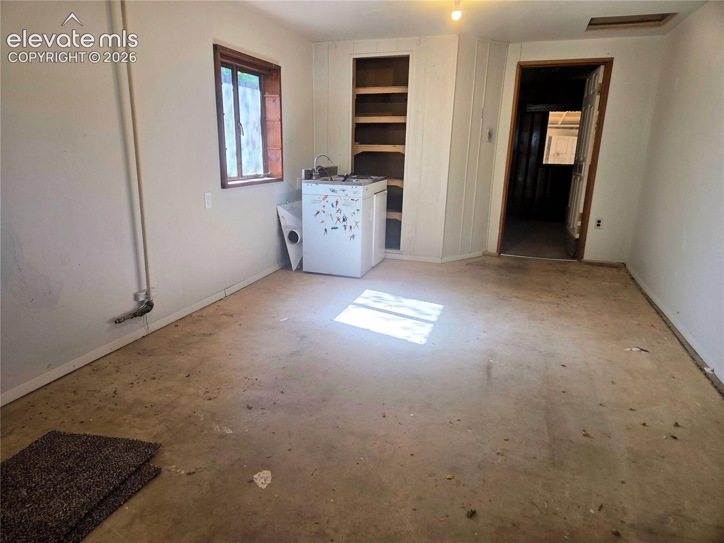 The east side of the same building. So many possibilities. An office/hobby room/game room/workshop... or another living space if finished out. 