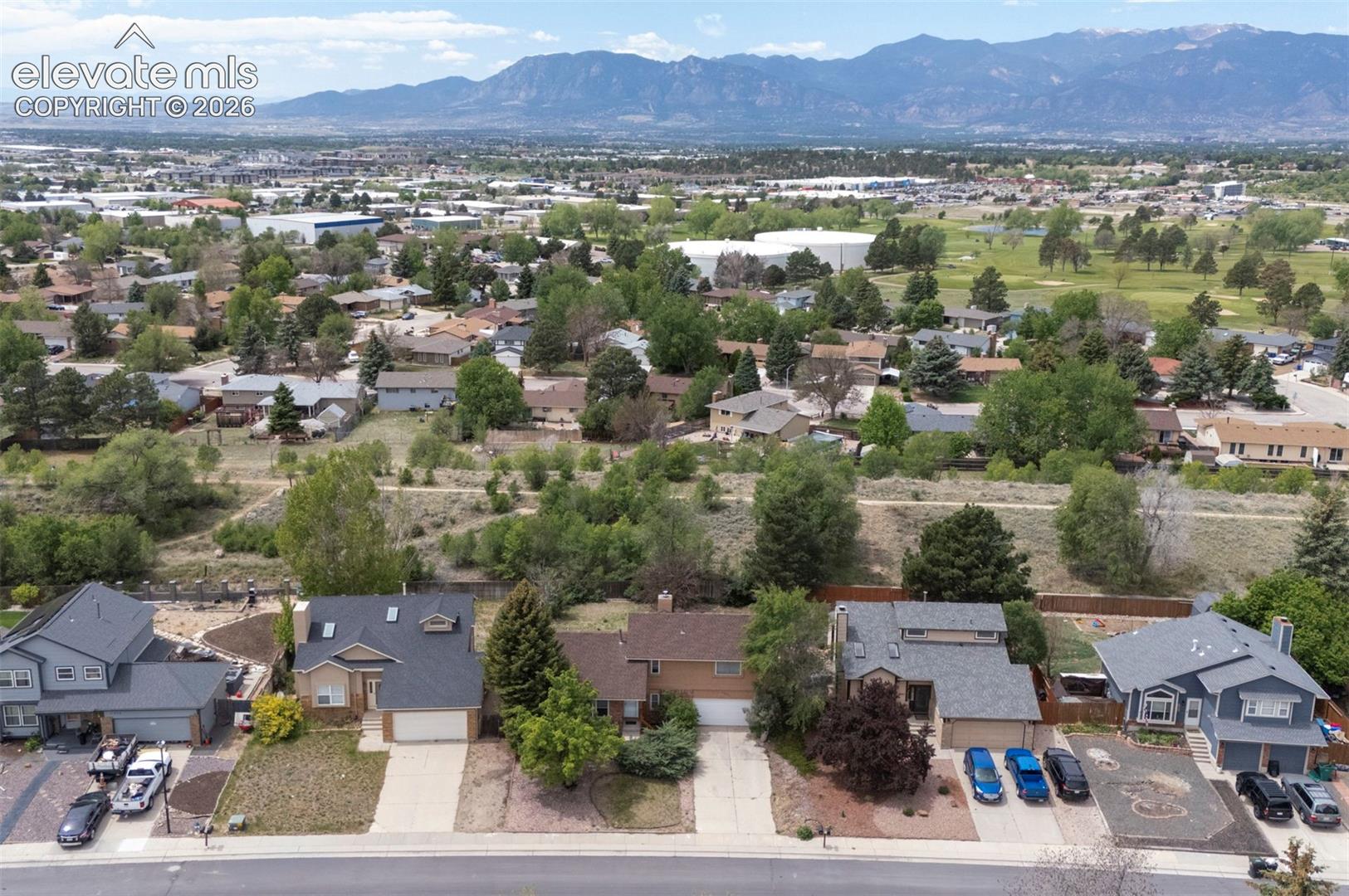 Aerial perspective showcasing a residential area with varied home styles and mature landscaping