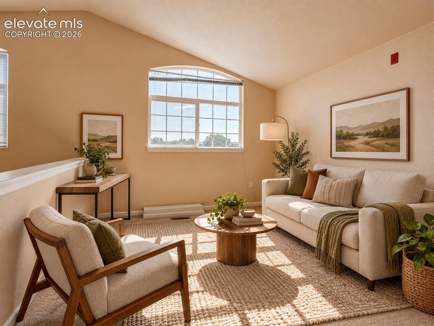 Vaulted ceiling featuring an arched-top window and neutral wall finishes
