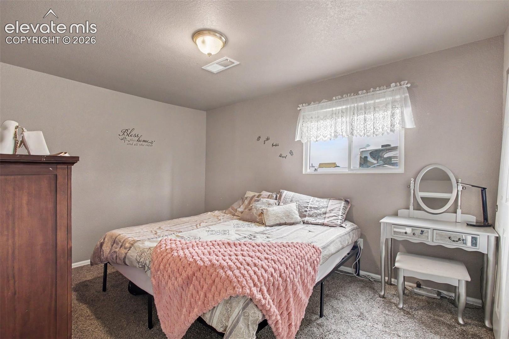Welcoming 3rd  bedroom with a cozy feel, providing flexibility for guests, hobbies, or additional living space.