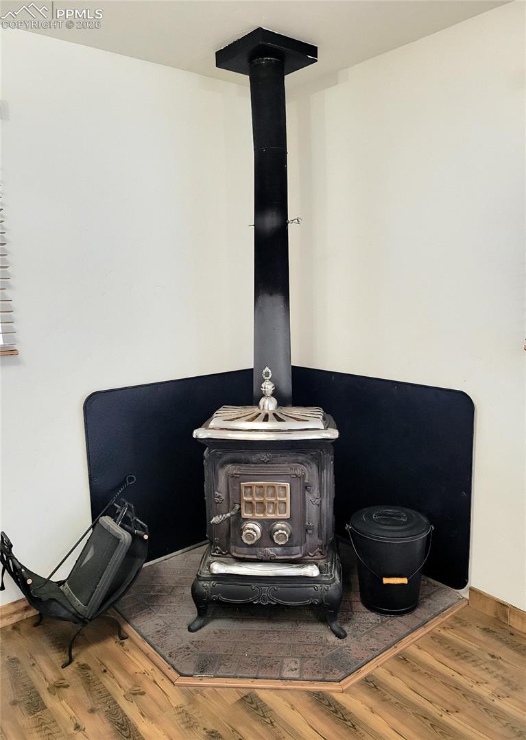 The living area features a corner wood-burning stove 