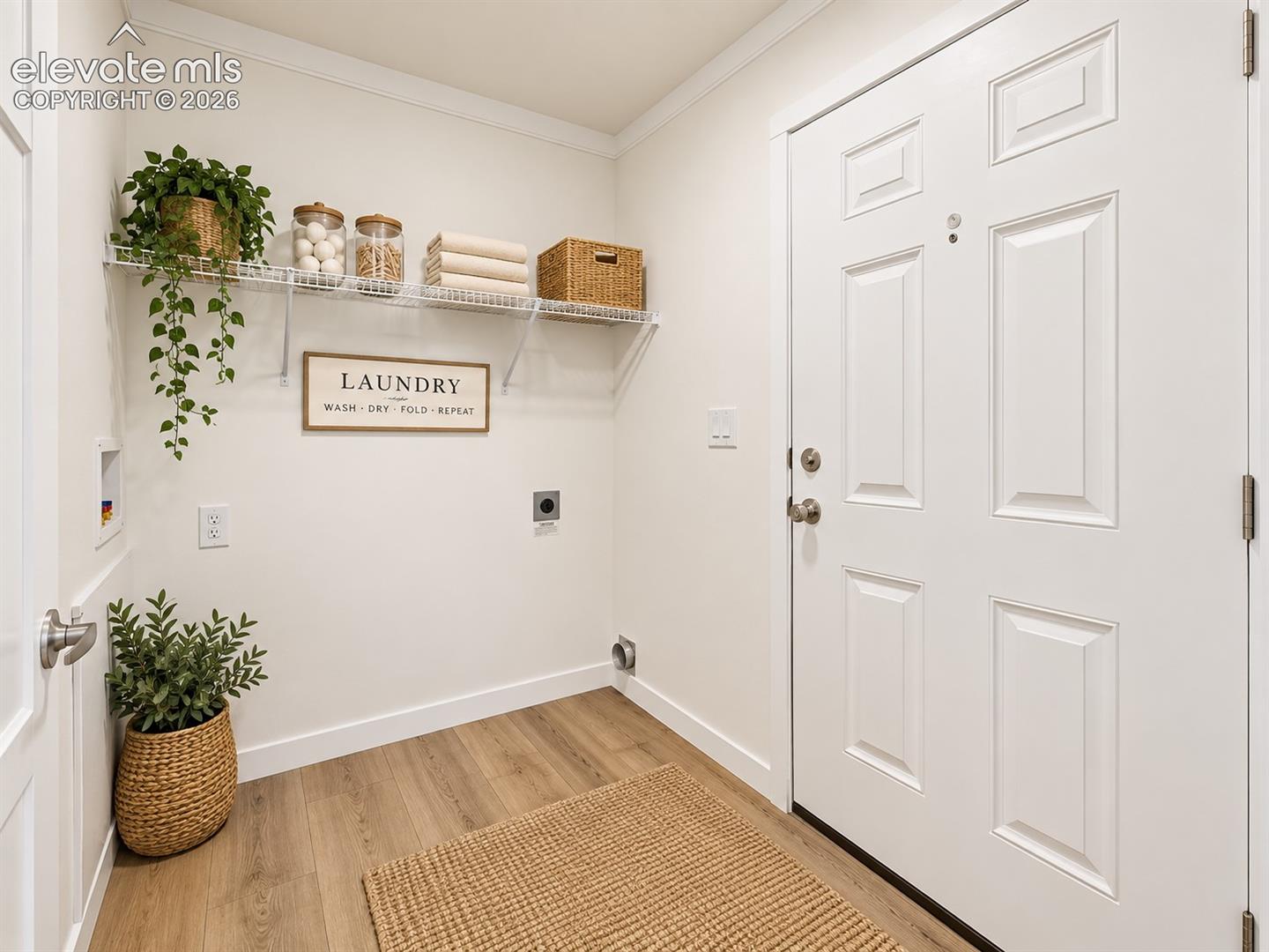Laundry Room – Dedicated laundry space offers washer and dryer hookups, overhead shelving for convenient storage, and durable flooring.