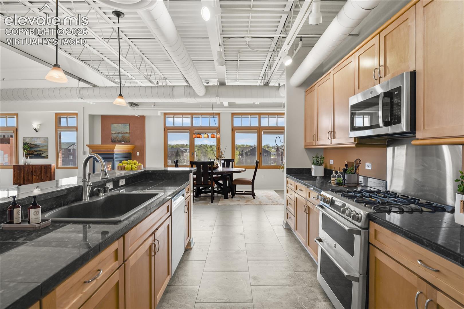 Granite countertops, a generous eating bar, stainless steel appliances including a gas range with double oven. Virtually Staged