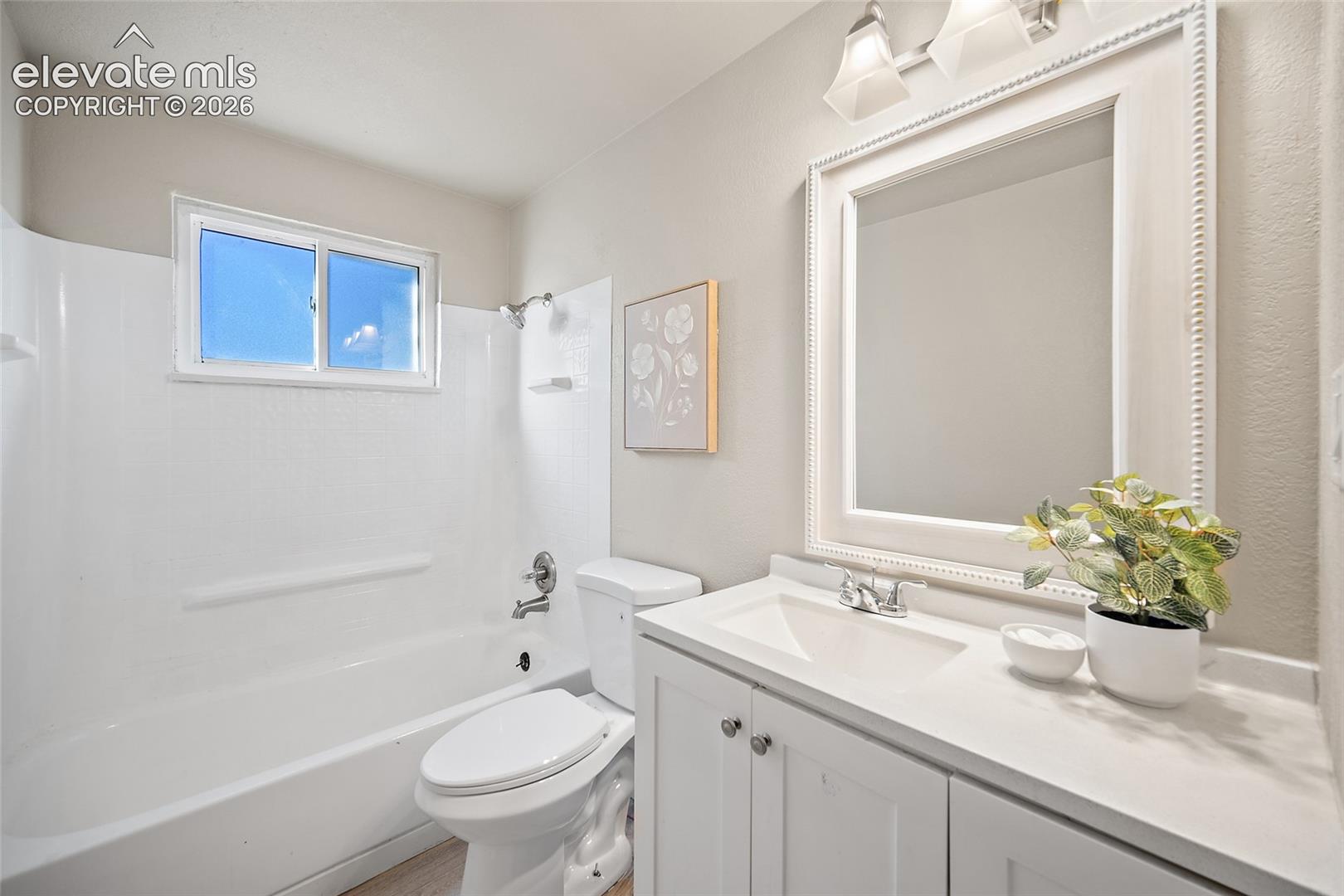 White vanity with an integrated sink and chrome faucet