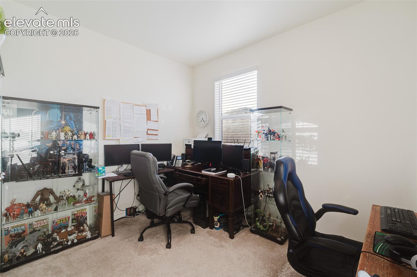 Main Level Bedroom (currently an office) with neutral carpet.