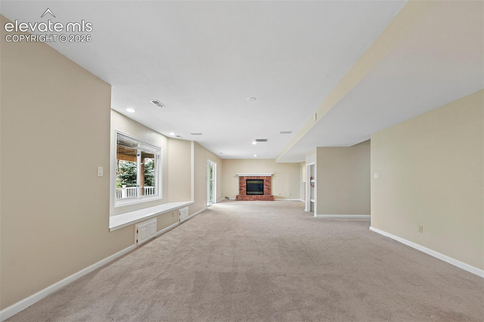 Large walkout basement with brick fireplace,  to lower level deck