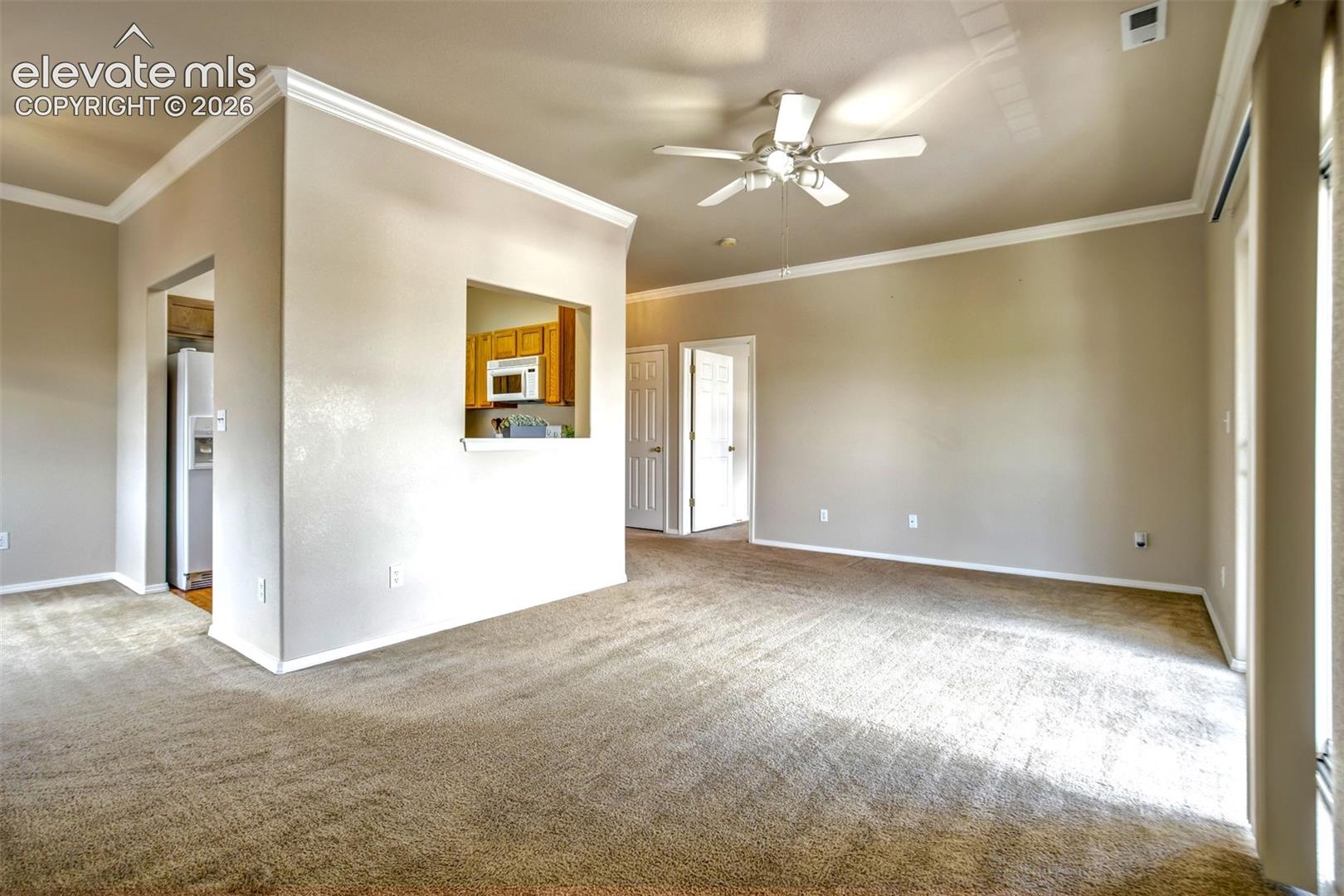 View of the living room, dining room and kitchen entrance