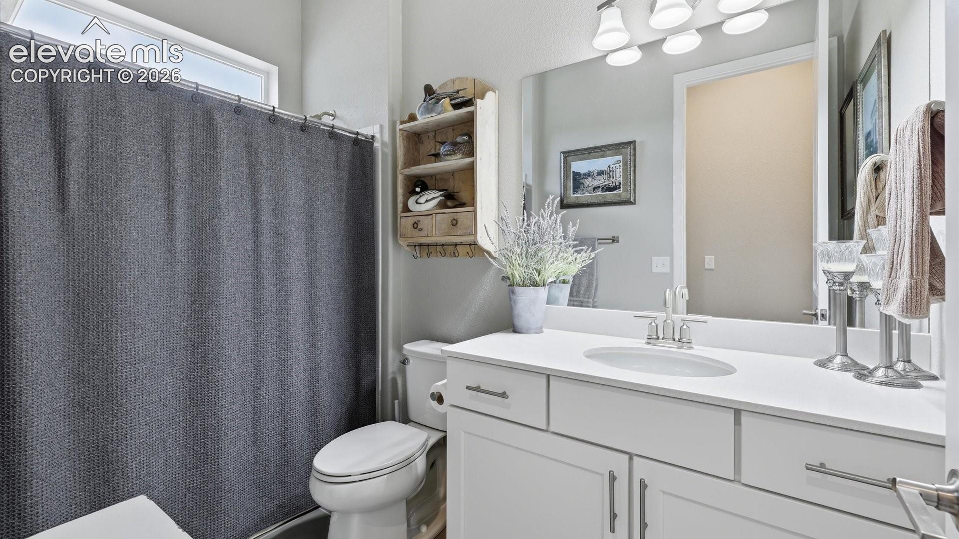 THOUGHTFUL DESIGN — Perfectly situated near both additional main-level bedrooms, this elegant hall bath combines convenience with refined finishes.