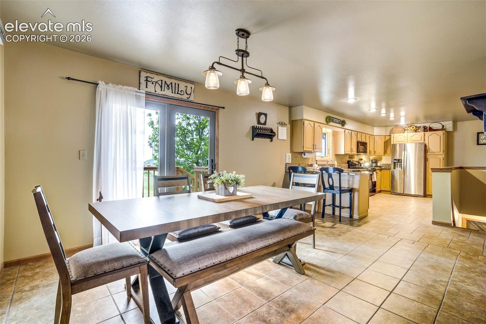 Large dining kitchen space -walkout to deck faces east, tiled flooring