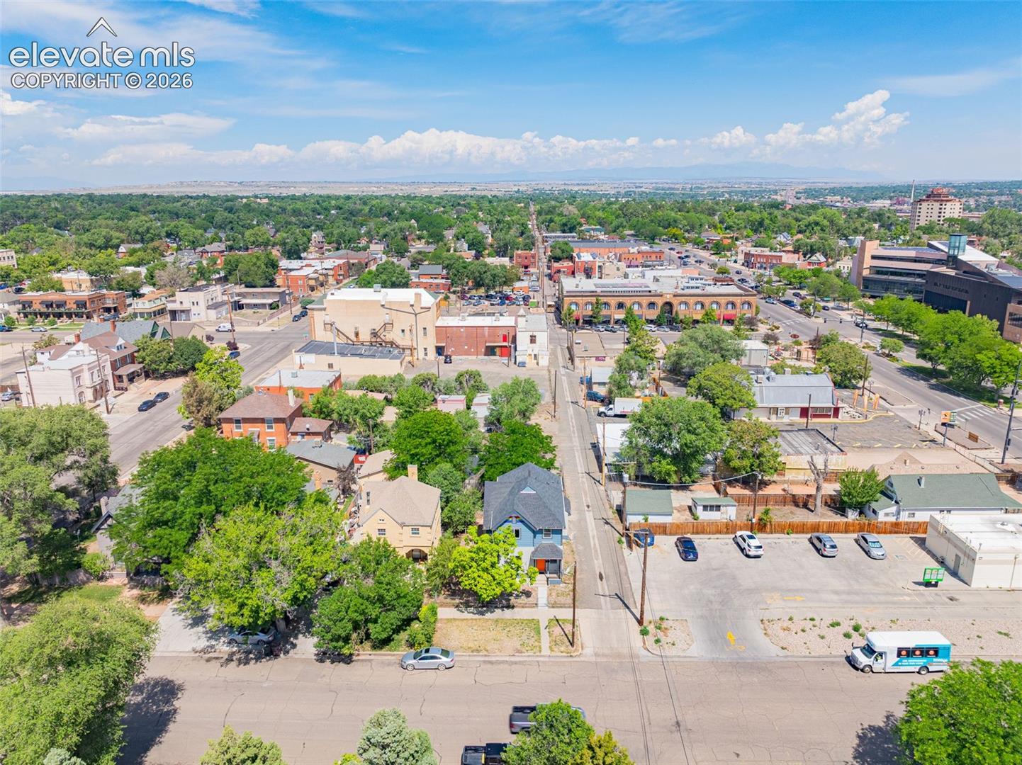 Aerial perspective showcasing a vibrant urban landscape with a mix of commercial and residential structures
