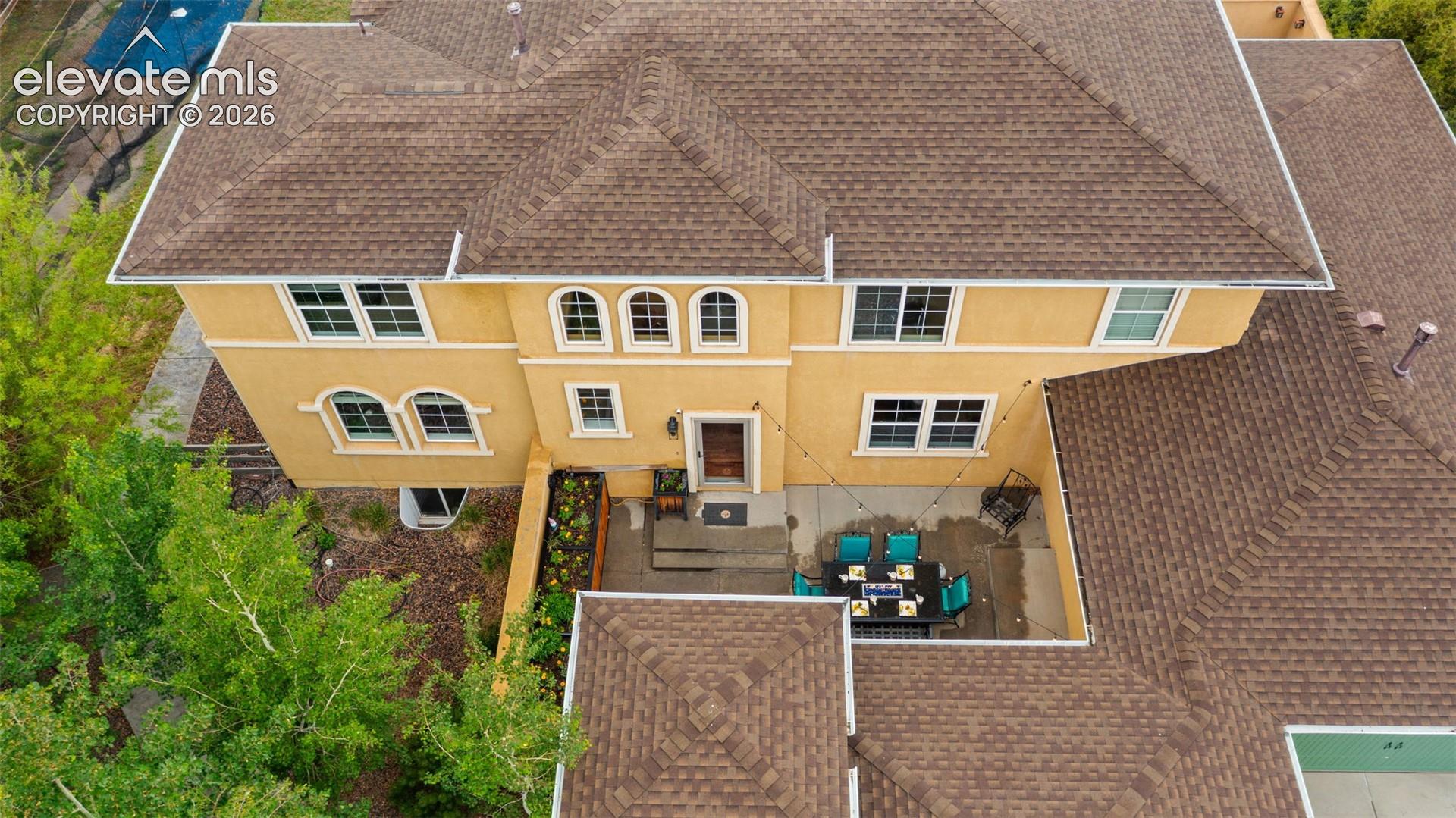 Stucco exterior with multiple windows, including arched designs