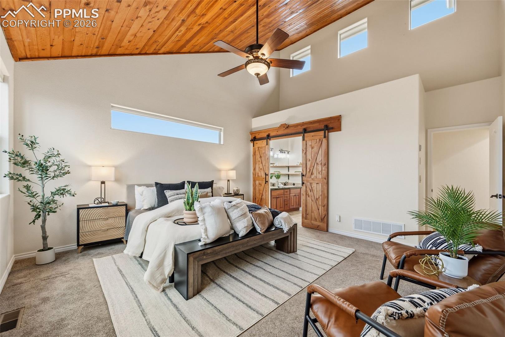 Barn doors lead to primary bath