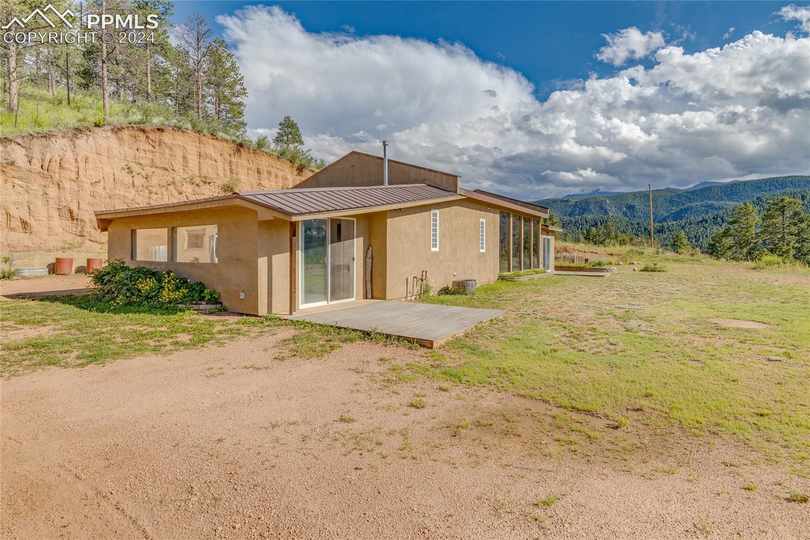 Back of property featuring a patio and a mountain view