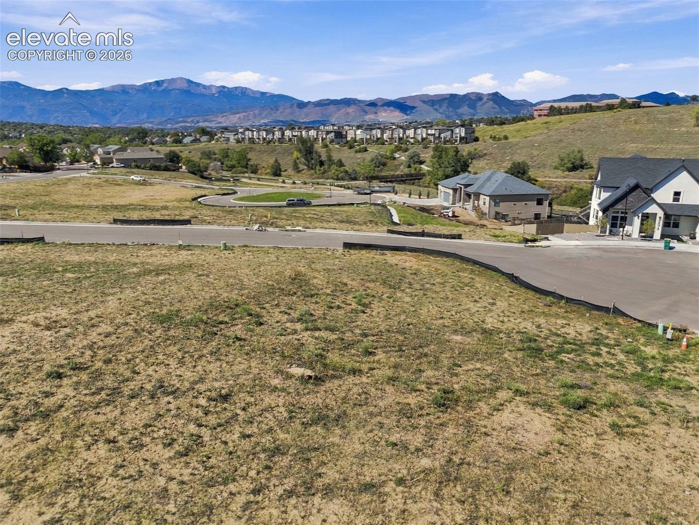 Expansive undeveloped lot with paved road frontage and mountain scenery