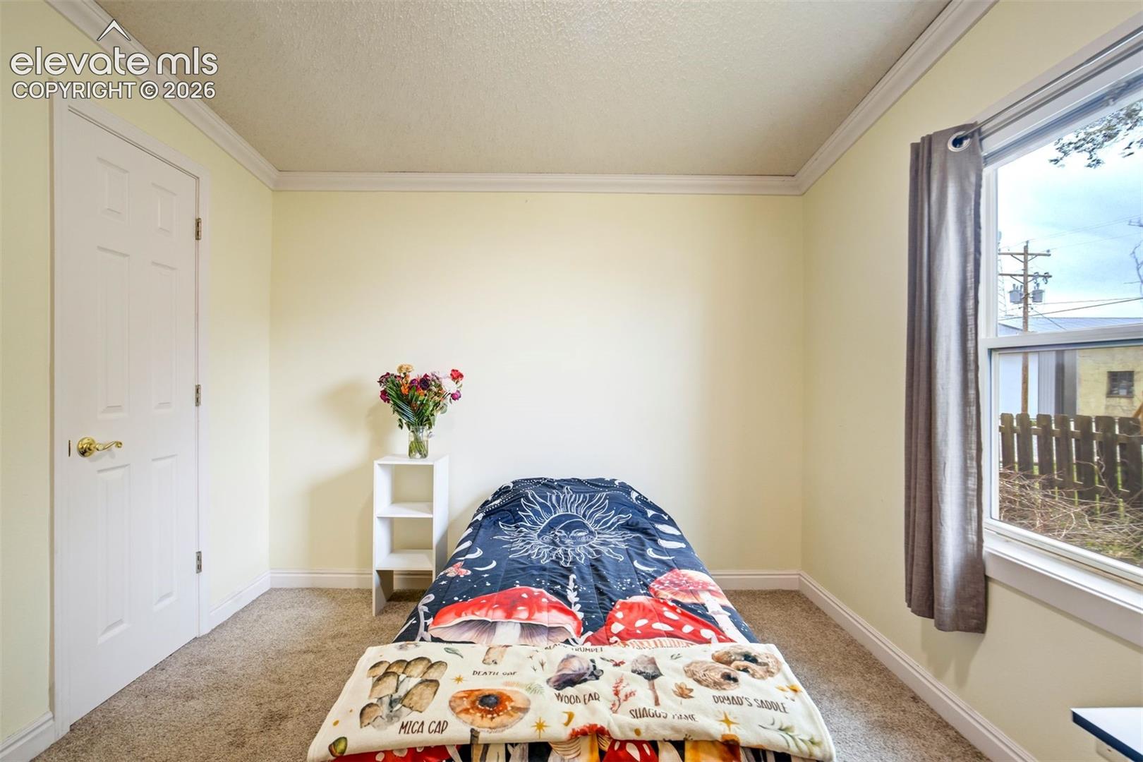 Comfortable third bedroom with soft natural light and neutral finishes.