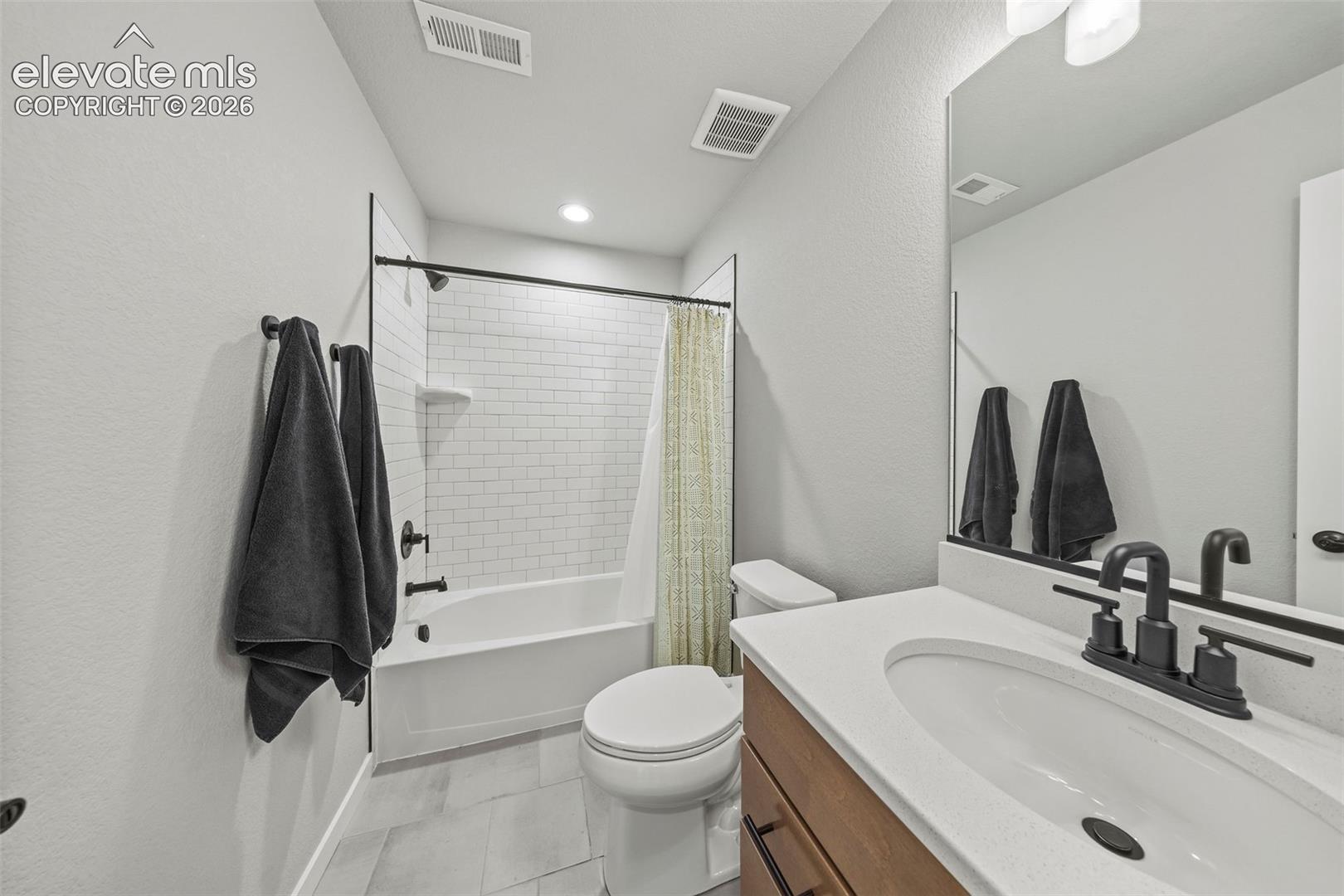 The lower-level bathroom is adjacent to the third bedroom and features a tub/shower combo and undermount sink. 