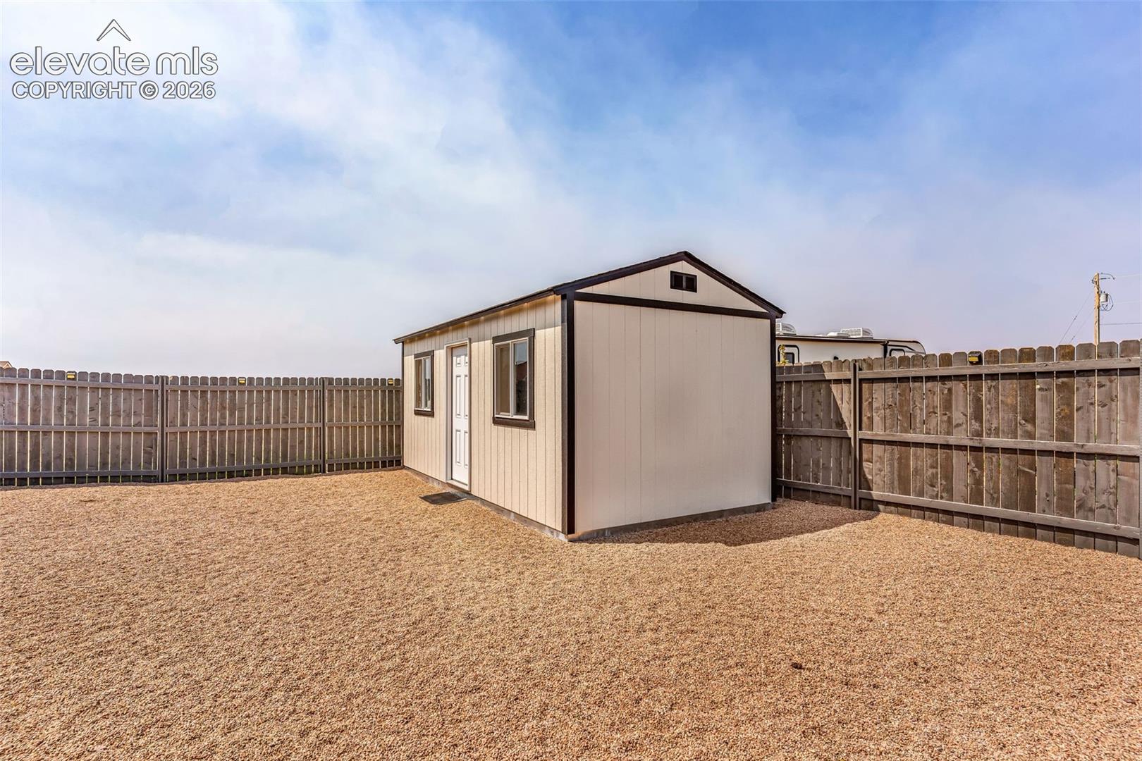 Dedicated storage shed featuring a single door, two windows, and a pitched roof