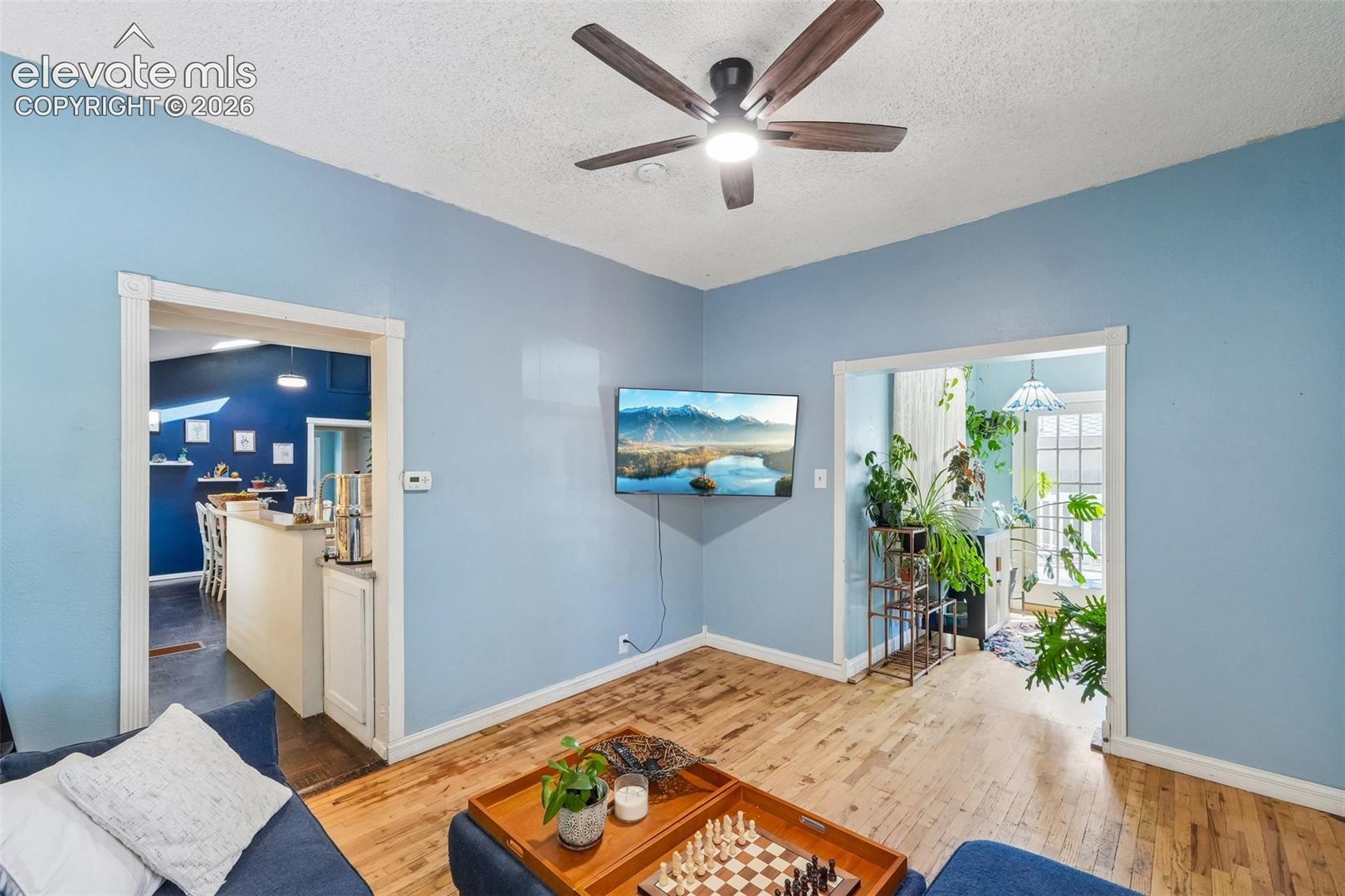 Living room looking to sunroom and kitchen