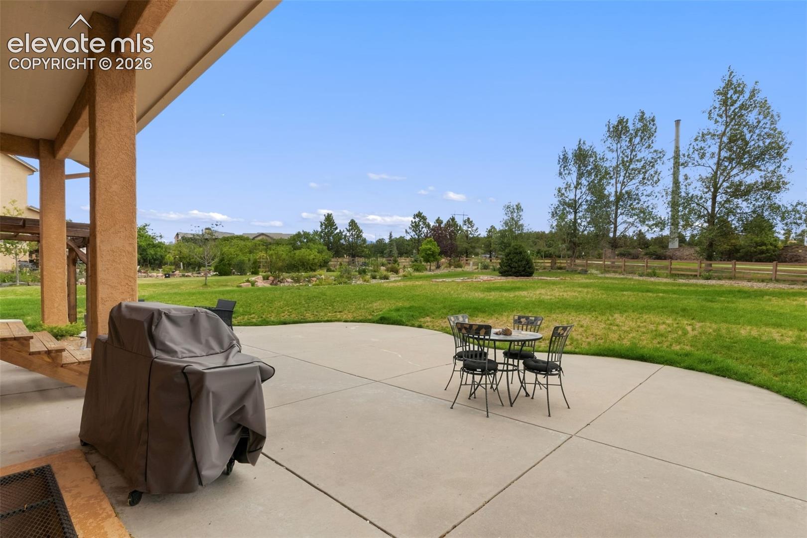 Expansive concrete patio with a covered area extending from the home
