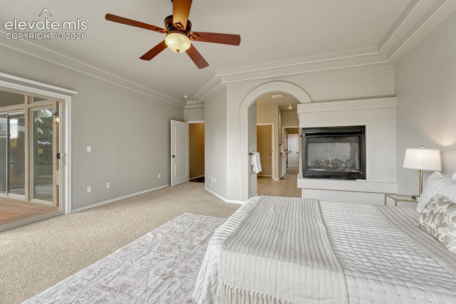 The Primary Bedroom boasts a 3-sided gas fireplace and arched entry into the adjoining 5-piece bathroom.