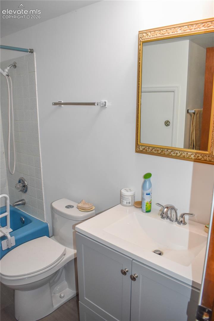 White bathroom vanity with undermount sink and chrome fixtures