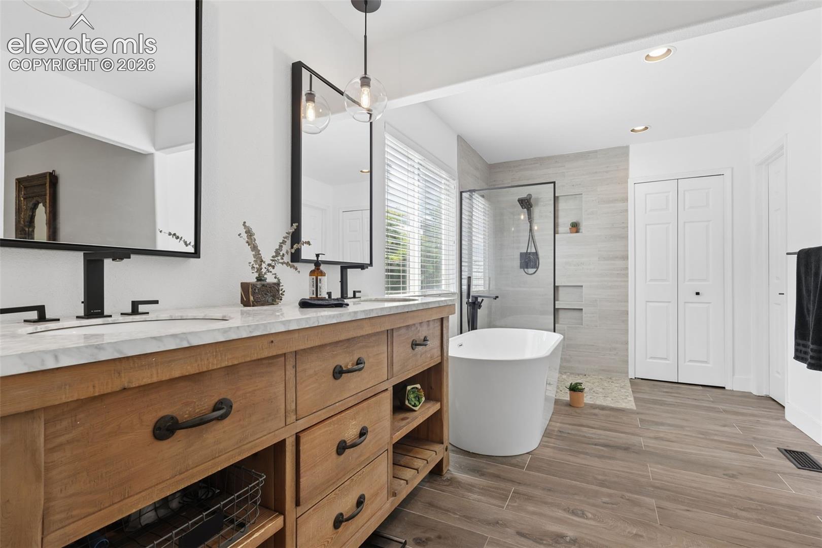 primary bathroom with double vanities- sinks/separate  garden-soaking tub and shower stall