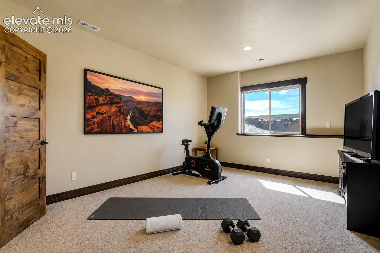 Basement guest suite #2 with private attached bath - currently serves as home gym