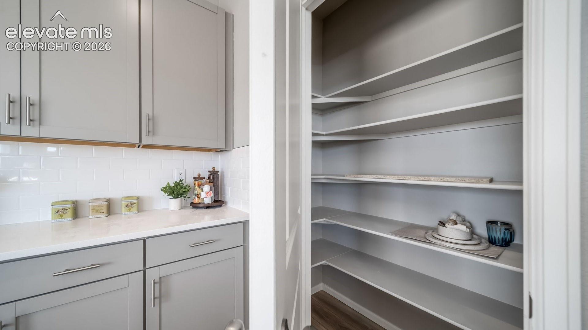 Walk-in pantry featuring extensive built-in shelving, providing abundant storage
Photos of a model home