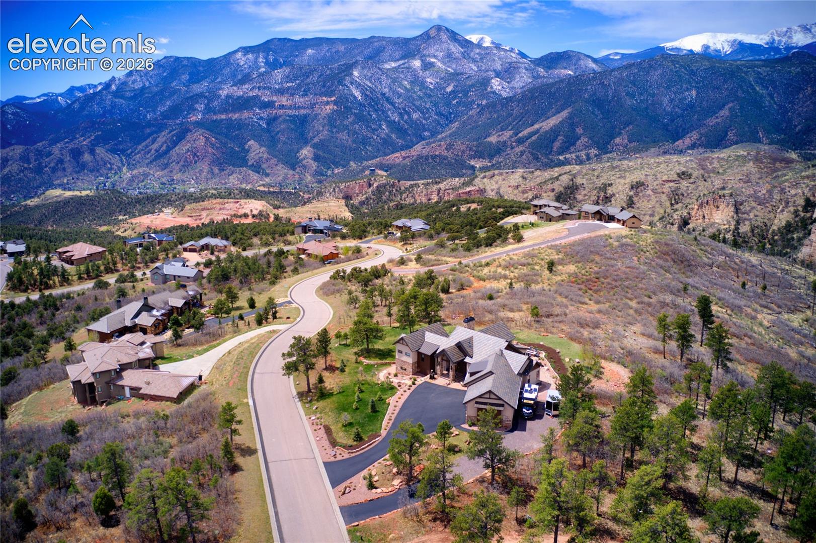 Tucked into one of Colorado Springs' most coveted hillside enclaves, with Pikes Peak as the permanent backdrop and 1.25 acres of privacy to call your own.
