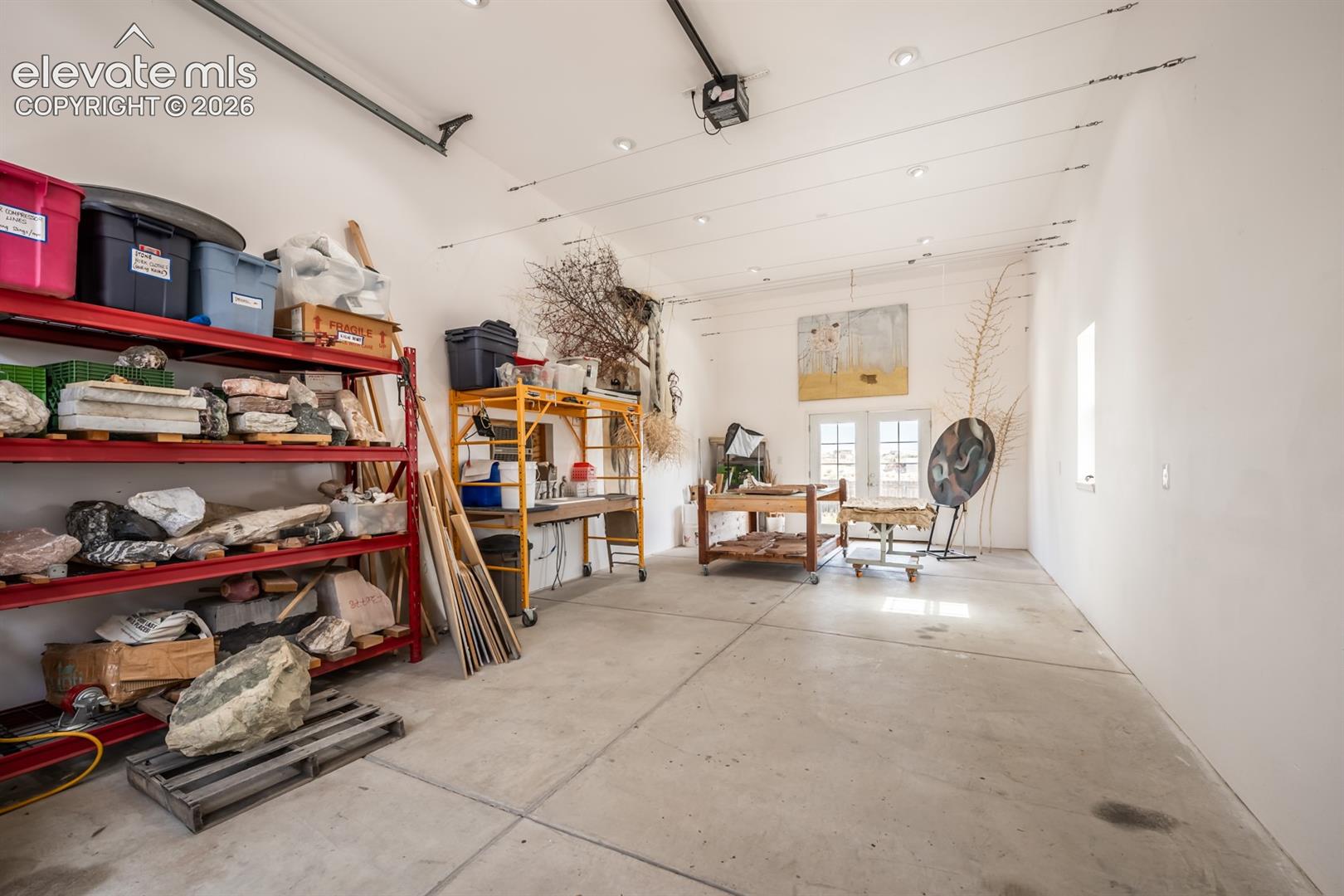 Workshop, RV garage or art studio.  Its finished with a swamp cooler and 220 for power. French doors one end and overszed garage doors at the front.