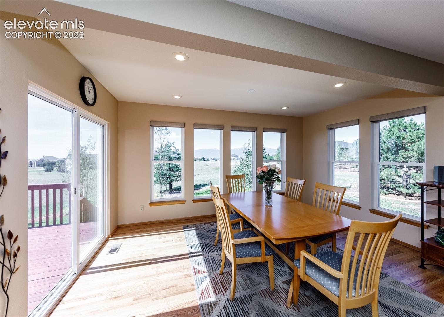 Dining area featuring wood-finish flooring, recessed lighting, and multiple windows