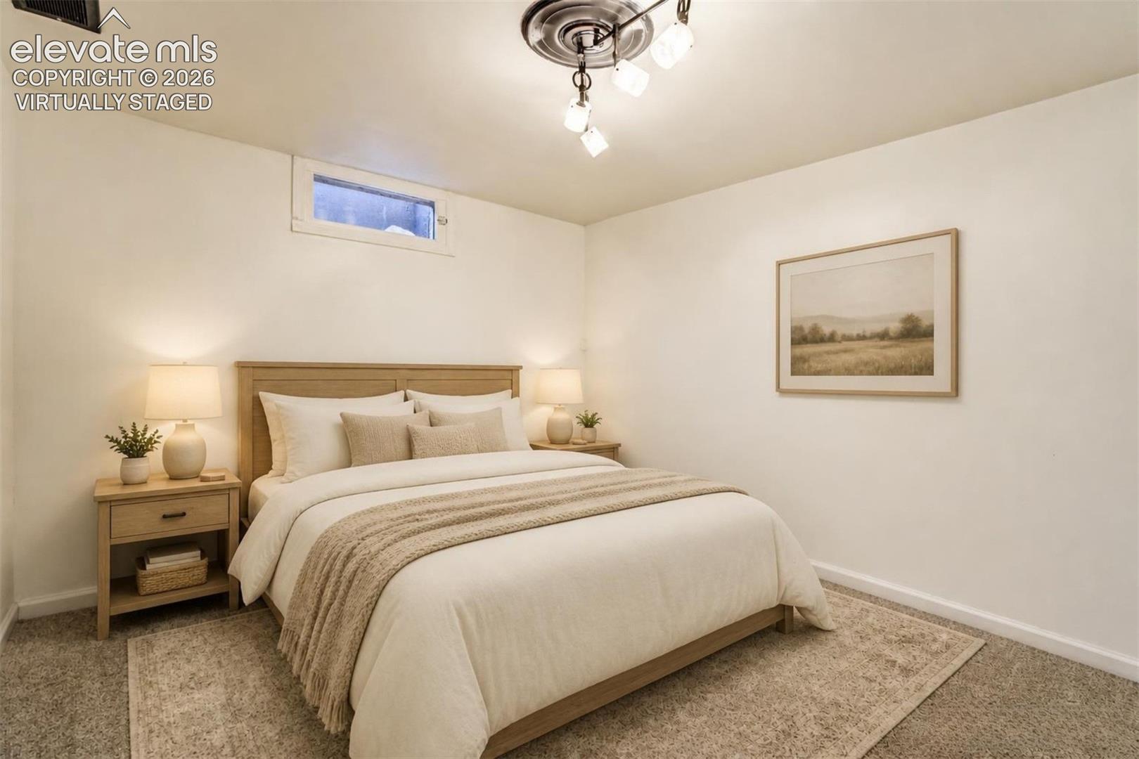 Virtually Staged.  Neutral interior space featuring carpeted flooring, a recessed window, and a multi-bulb flush-mount light fixture with a decorative ceiling medallion