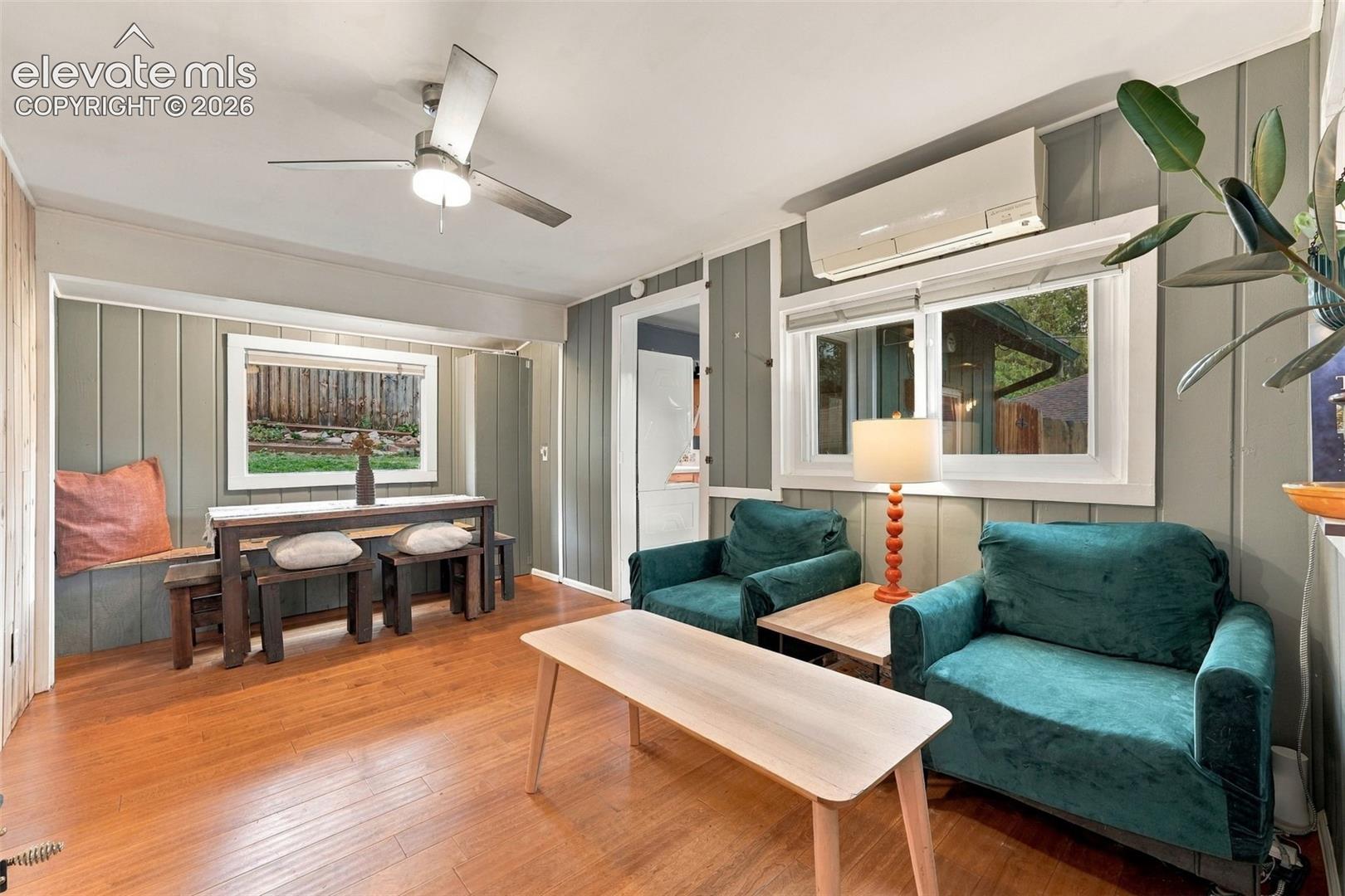Living area featuring wall-mounted climate control unit.