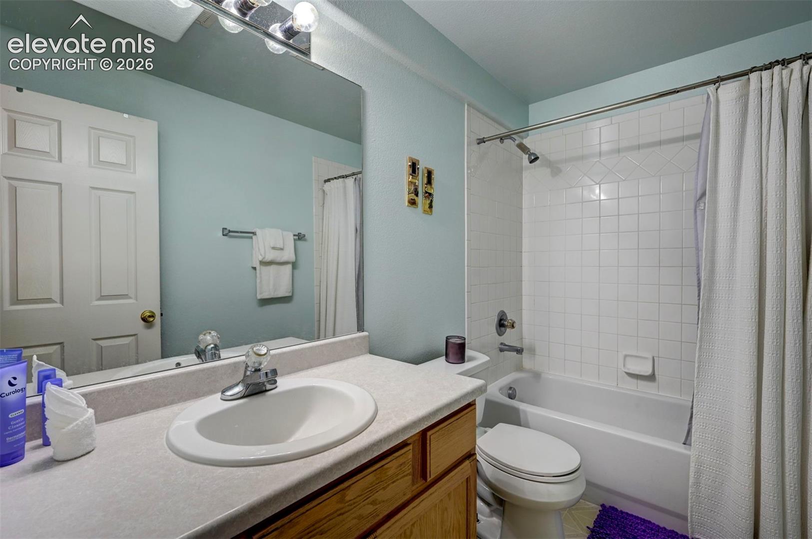 Full bathroom in basement featuring vanity and shower / bathtub combination.