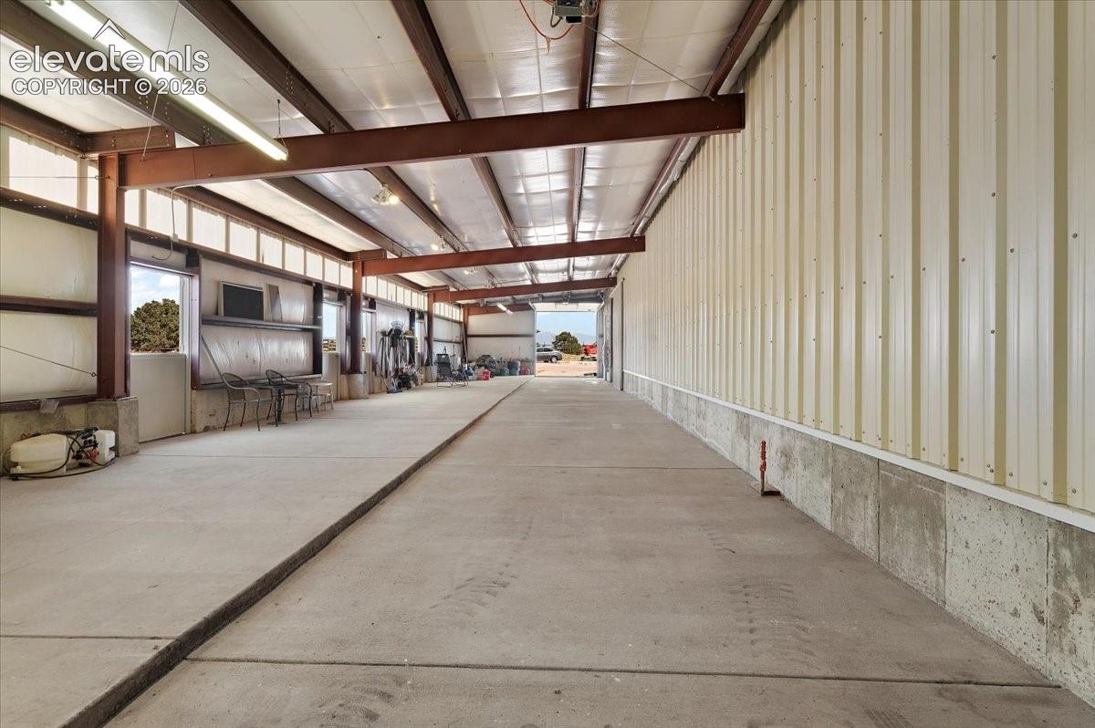 View of stall area from other end of building. Stall doors all access the turn out area that measures 72 ft. X 120 ft. and has pipe fencing