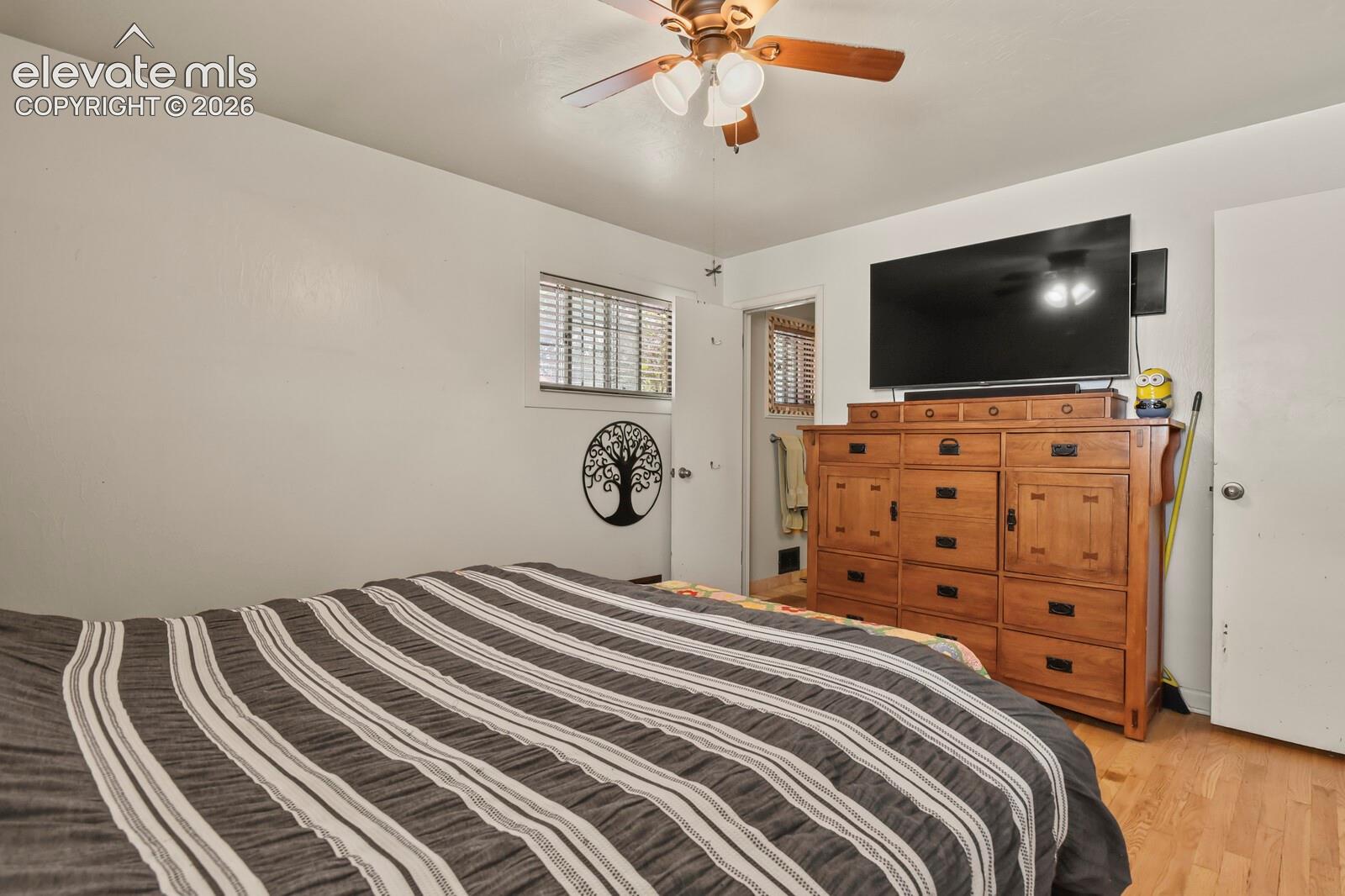 Wood-finish flooring with a ceiling fan light fixture