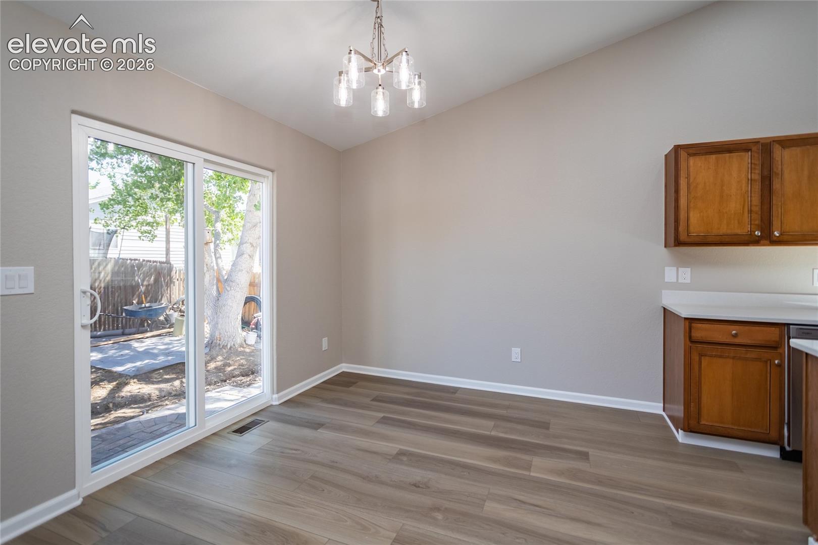Attractive light fixture & sliders out to the patio!