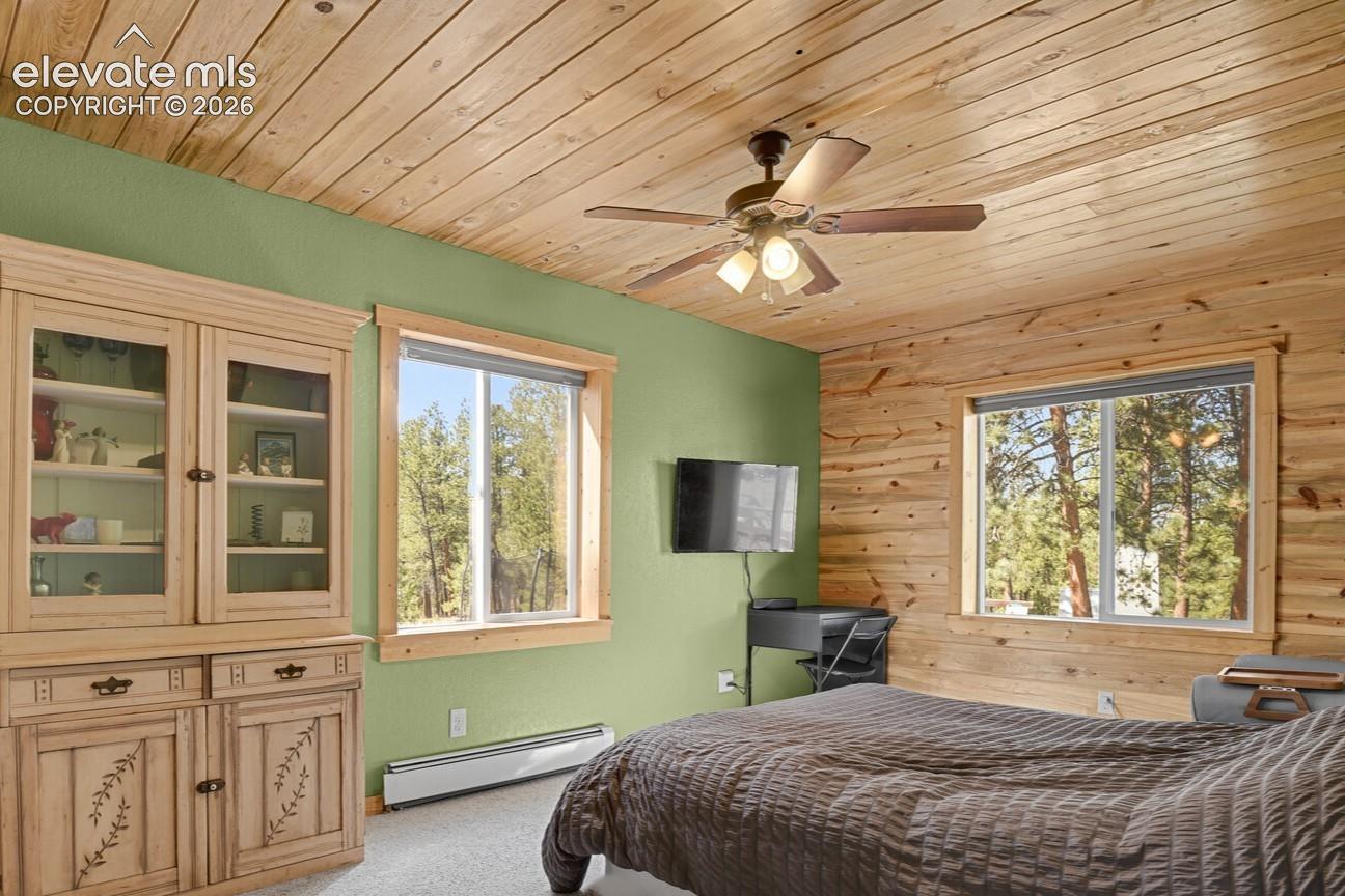 Primary Bedroom featuring beetle kill tongue and groove on ceiling and one wall