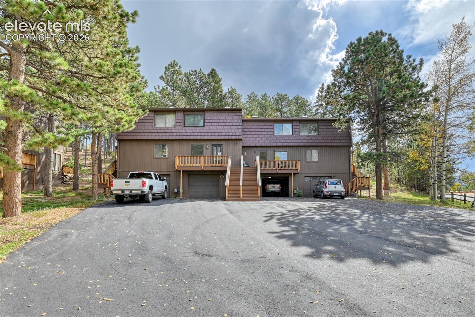 Welcome to 590 Manor Ct #B, a charming townhome tucked among the mature pines in the heart of Woodland Park. Offering approximately 1,440 square feet with 2 bedrooms, 3bathrooms, and an attached 1-car garage, this home combines mountain living with everyday convenience.The main level features an open and comfortable living space highlighted by a wood-burning fireplace, creating a warm Colorado mountain atmosphere. Step outside onto the back deck and enjoy the peaceful wooded surroundings—an inviting setting for morning coffee, relaxing after a long day, or simply enjoying the fresh mountain air.Both bedrooms are located upstairs, while the lower level provides additional storage and convenient access to the attached garage. The property is located close to shopping, restaurants, schools, hiking and outdoor recreation, with easy access to Highway 24 for commuting to Colorado Springs.Whether you are looking for a primary residence, mountain getaway, or investment opportunity, this Woodland Park townhome offers an attractive combination of location, space, convenience, and Colorado mountain lifestyle.Property is being sold AS-IS, providing buyers with an opportunity to make the home their own. Come see the potential that 590 Manor Ct #B has to offer!