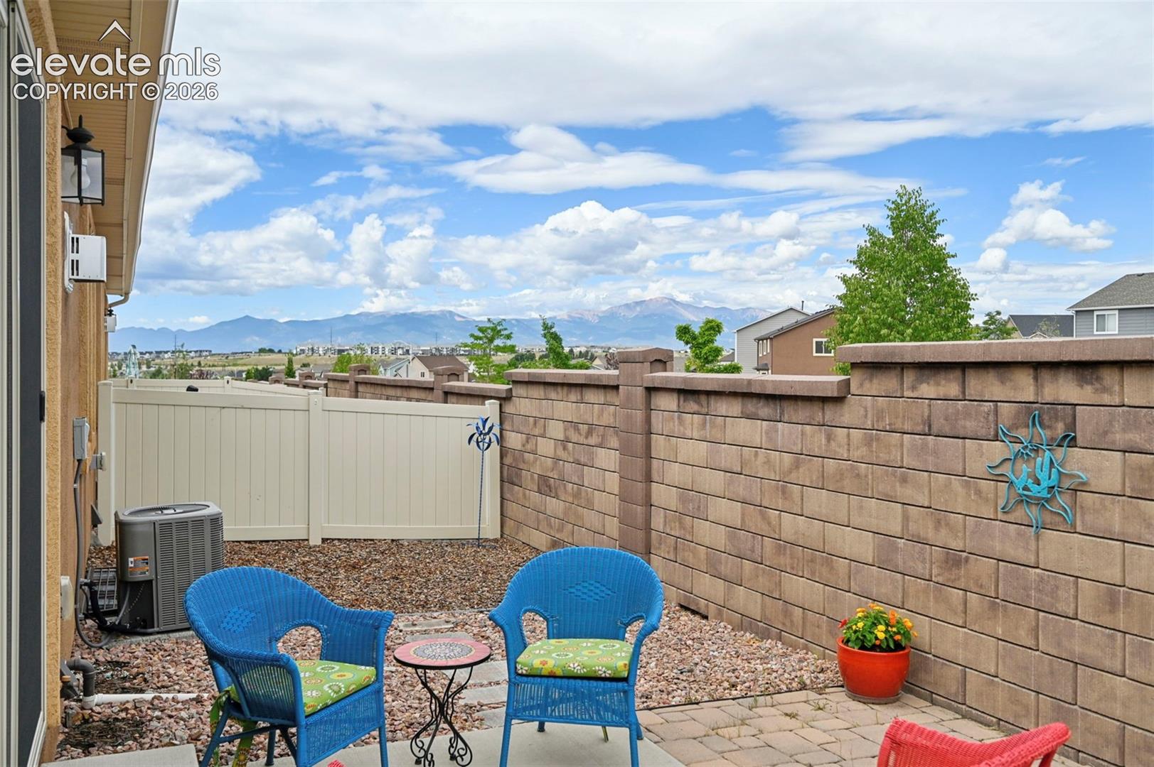 Outdoor patio featuring paver stones and a stone block privacy wall - look at the view!