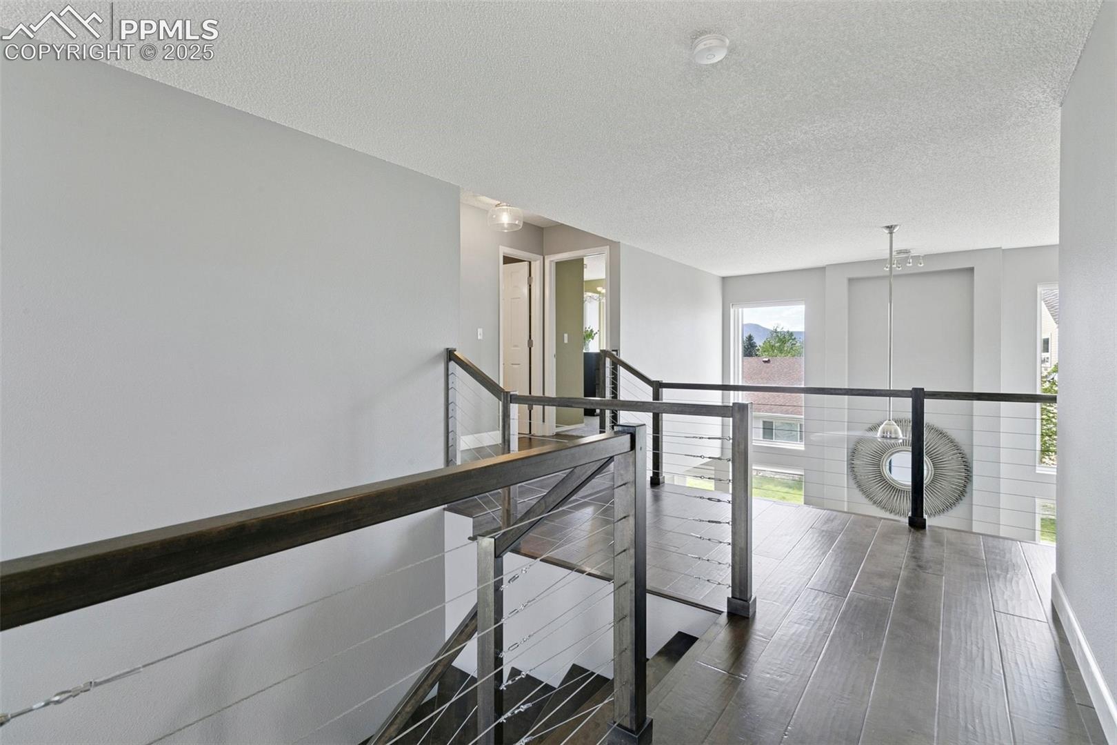 The landing features engineered birch floors, custom birch railings and metal cables