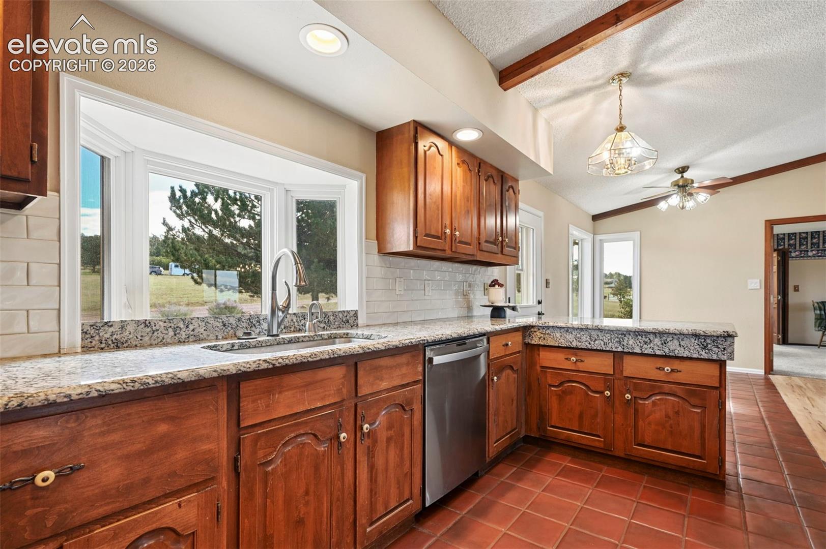 Tile backsplash, stainless appliances, hot water tap, granite countertops