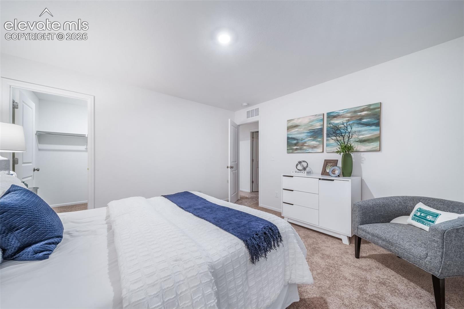 Carpeted flooring, white walls, built-in closet shelving, and a ceiling light fixture
*photos of a model home*